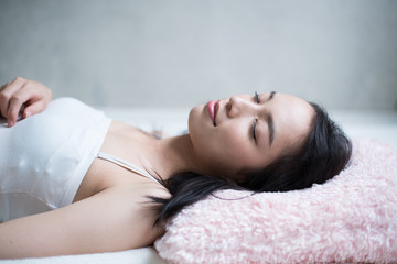 Fototapeta na wymiar Young woman sleeping on bed