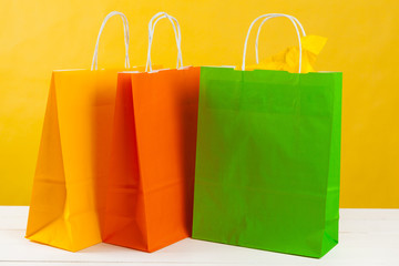 Arrangement of shopping bags on bright yellow background