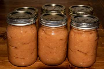 Six jars of canned apple sauce