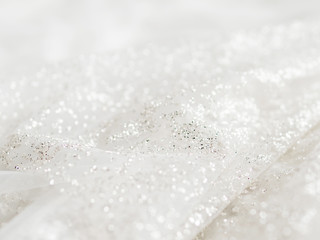 Bride's white dress with sparkling spangles. Bridal traditional clothing for wedding ceremony.