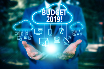 Writing note showing Budget 2019. Business concept for estimate of income and expenditure for current year Male wear formal work suit presenting presentation smart device