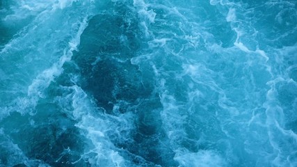 Blue sea water with boat trace. Slow motion.