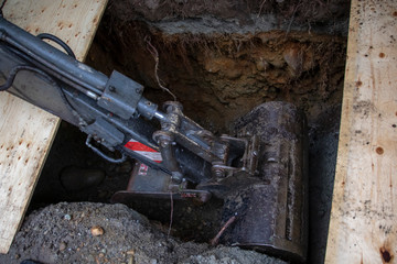 A backhoe in a trench