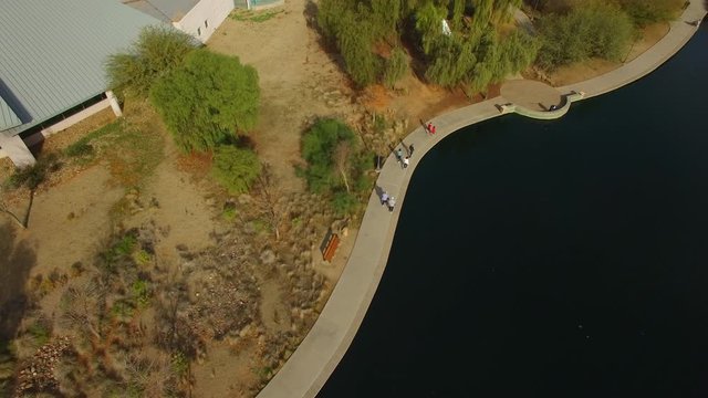 Gilbert Riparian Preserve with people walking next to the lake, aerial drone footage.