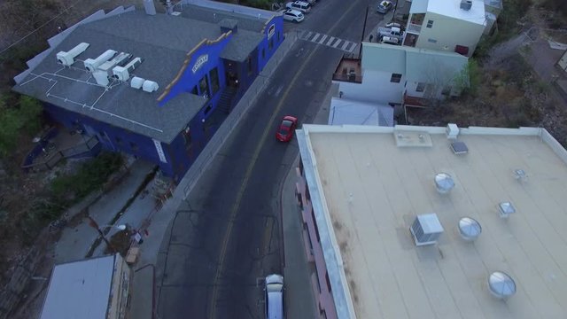Aerial drone footage of Bisbee Arizona flying over the old historic mining town at sunset.