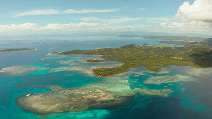 Tropical landscape: islands and atolls with blue water against the sky and clouds. Bucas grande, Philippines. Summer and travel vacation concept.