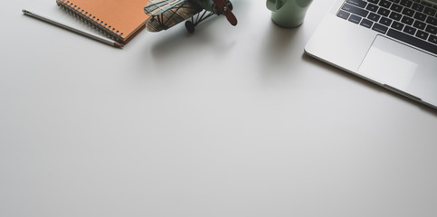 Modern workplace with laptop and office supplies on white desk background