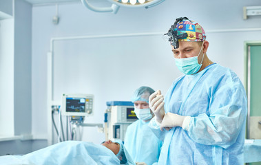 Several doctors surrounding patient on operation table during t