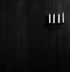 candlestick with candles on a black wall