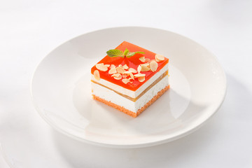 Vanilla souffle with red strawberry glaze on white plate isolated on white background