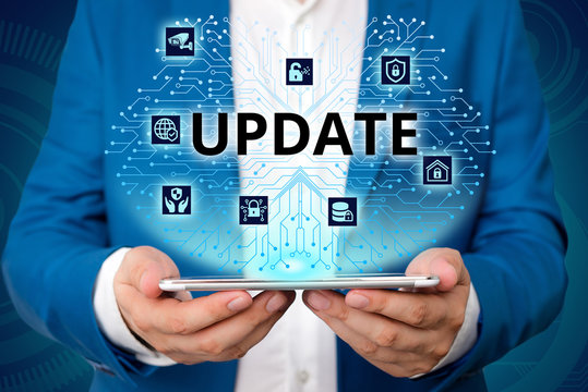 Handwriting text writing UPDATE. Conceptual photo make something more modern or up to date like software program Male human wear formal work suit presenting presentation using smart device