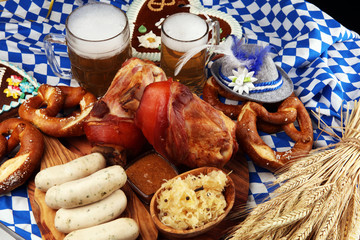 Fototapeta na wymiar Traditional German cuisine, Schweinshaxe roasted ham hock. Beer, pretzels and various Bavarian specialties. Oktoberfest background