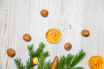 Christmas and New Year composition. Pine branches, cinnamon sticks, dried slices of orange and walnuts. Christmas and New Year concept. Flat lay.
