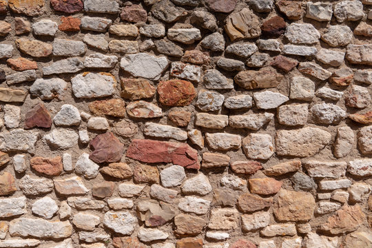 Stone wall background texture of dry masonry