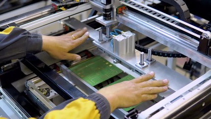 engineer removing nozzle from machine at surface mount Technology, SMT for maintenance and clearing, place to electronic equipment, blur background