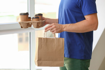 Worker of food delivery service indoors