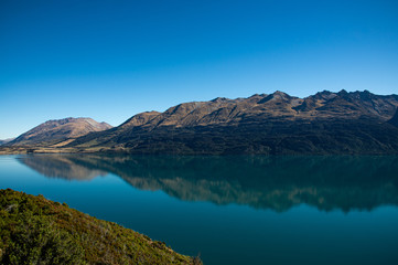 Naklejka na ściany i meble Amazed nature scenic landscape of invisibly mountain, clear blue sky reflection in turquoise lake, popular view point on the way to Glenorchy, South New Zealand.