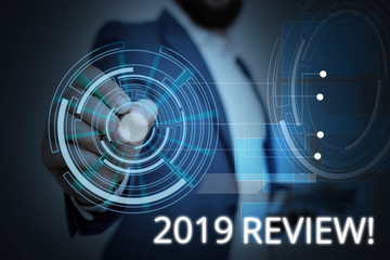 Writing note showing 2019 Review. Business concept for remembering past year events main actions or good shows Male wear formal suit presenting presentation smart device
