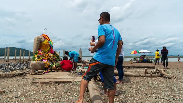 time lapse of people visit the ruins of Nong-Bua temple under the water of Pasak Jolasid Dam after the water reduced in Lopburi, Thailand