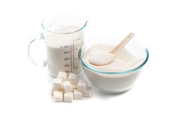 .glass beaker and bowl with sugar isolated on white background