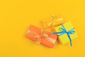 Obraz na płótnie Canvas Different colored gift box on color background. Top view of various present boxes on minimal background. Birthday, Christmas, wedding, valentine, romantic gifts - Image