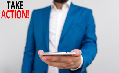 Word writing text Take Action. Business photo showcasing do something official or concerted to achieve aim with problem Business concept with man holding mobile phone with touch screen