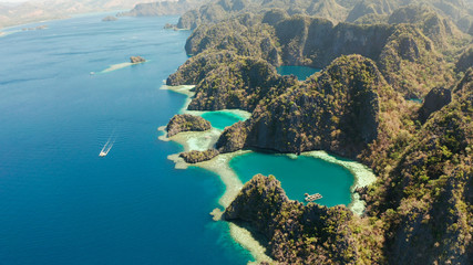 Tourist boats around the beautiful big and small lagoons, aerial view. lagoon, mountains covered...