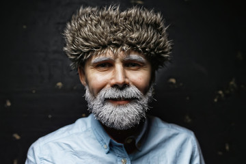 Santa Claus hipster / portrait of a fashionable modern Santa, young man with a gray beard, Christmas winter portrait