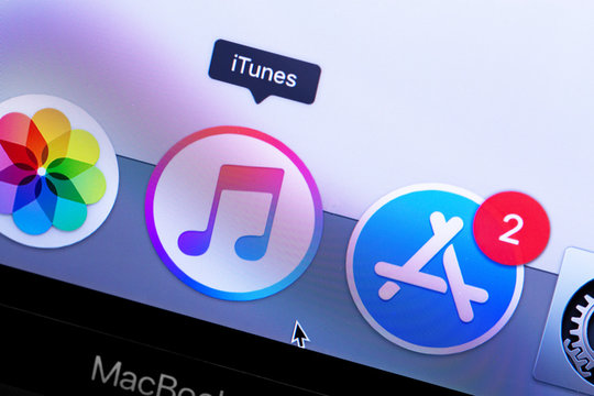 Apple Macbook with iTunes and App Store icons app on the screen. App Store is a digital distribution service for apps on iOS and MacOS platform, developed by Apple Inc. Moscow, Russia - May 10, 2019