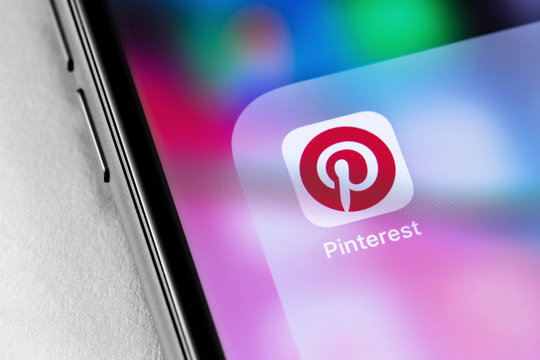 closeup smartphone with Pinterest icon app on the screen. Pinterest is a social internet service, photo hosting. Moscow, Russia - June 28, 2019