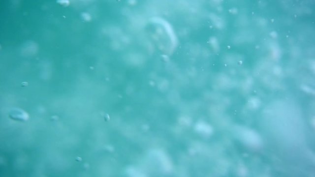 Bubbles rising to the surface. Air bubbles in water in sea (underwater shot), good for backgrounds. Slow motion.
