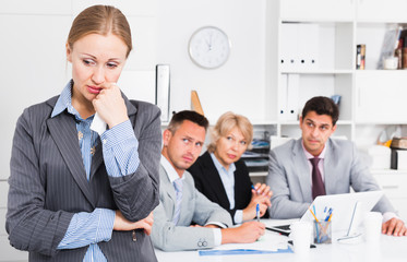 Fototapeta premium Crying woman at office on background with coworkers