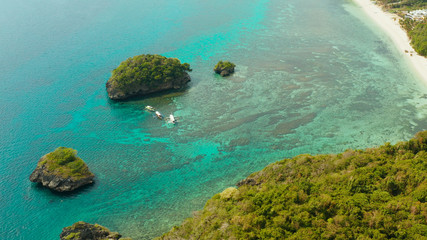 Fototapeta na wymiar Tropical sandy beach near the blue lagoon and corall reef, aerial view Boracay, Philippines. Ilig Iligan Beach. Summer and travel vacation concept.