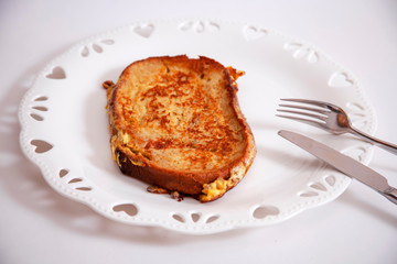 egg toast on white porcelain plate with heart (fried in hot oil)