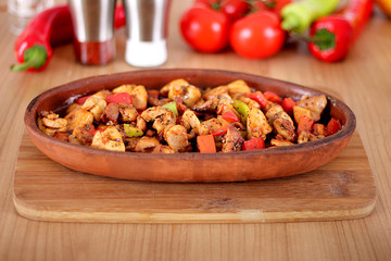 Chicken pepper tomato turkey feed in clay pot