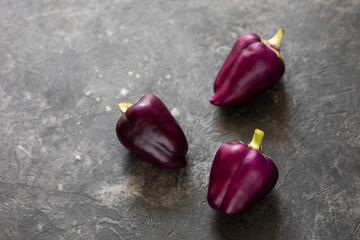 Fresh vegetables. Purple pepper on a dark background