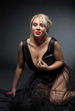 Beautiful sexy model, erotick studio shoot. At grey background.