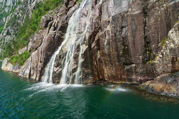 Fototapeta na wymiar Waterfall with rainbow sea view, Lysefjord, Norway