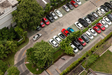 Aerial view of parking in the condominium with green trees