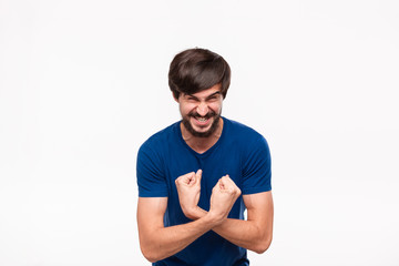 Obraz premium Funny good looking brunet bearded man with mustaches in a blue shirt showing biceps standing isolated over white background.