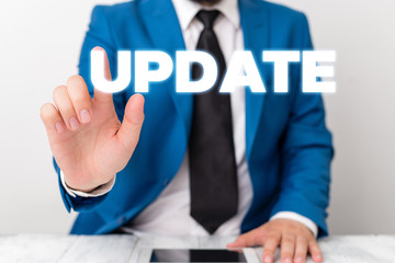 Handwriting text writing UPDATE. Conceptual photo make something more modern or up to date like software program Businessman with pointing finger in front of him