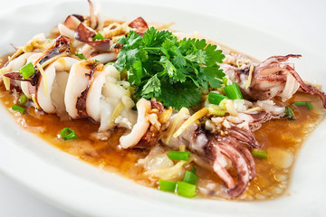 Chinese Cantonese cuisine home cooking, a dish of garlic steamed tubule squid on a white background