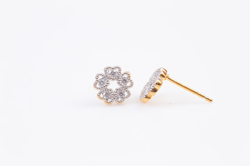 Gold earrings with diamond-shaped flowers on the white background.