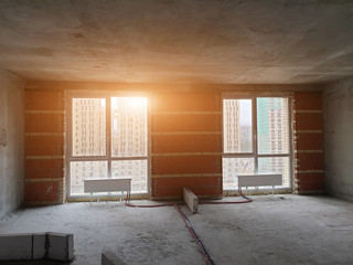 huge space of new luxury modern apartment with floor-to-ceiling windows in apartment building under construction