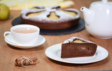 Fototapeta na wymiar Piece of homemade chocolate cake with pears and tea