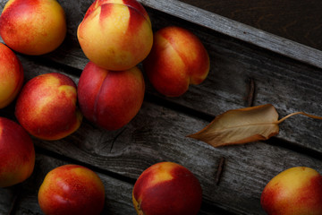 Fresh ripe nectarine in a box on a wooden table