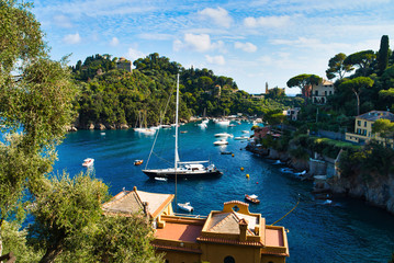 Portofino, Italy - AUGUST 15, 2019: Beautiful harbor in the Italian Riviera, houses on a cliff,...