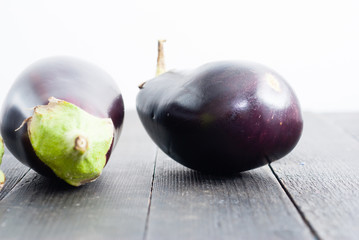 eggplants on black wood table background