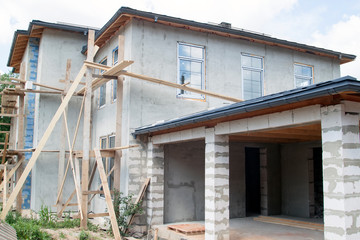 facade of cottage under construction with new inserted windows