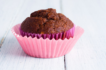 chocolate muffin on white wooden table